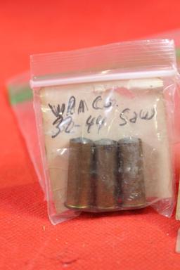 Three small bags with antique brass pistol rounds. One with 2 rounds of 38-44, one with 1 round of