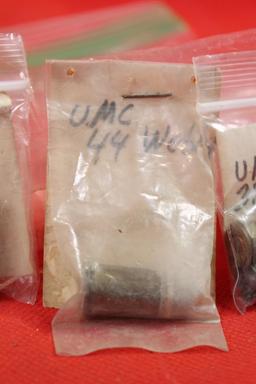 Three small bags with antique brass pistol rounds. One with 2 rounds of 38-44, one with 1 round of