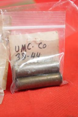 Three small bags with antique brass pistol rounds. One with 2 rounds of 38-44, one with 1 round of