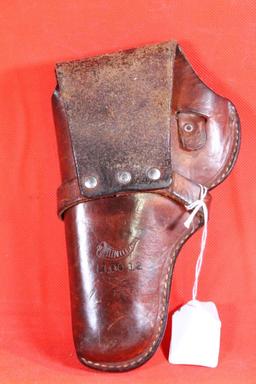 Brown leather right handed single strap belt revolver holster with trigger loop. Used.