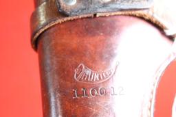 Brown leather right handed single strap belt revolver holster with trigger loop. Used.