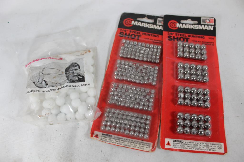 Two packs of Marksman hunting shot and a bag of white hard plastic balls to use with slingShot. In