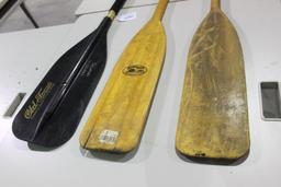 Three boat paddles. Used. Two wood and one fiberglass. 5 ft.
