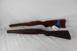 Two wood rifle stocks. One is damaged. Used.