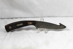 Schrade model 158OT skinning knife with gut hook. 4.5 inch blade. Non-original leather sheath. Both