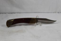 Schrade Uncle Henry folding hunter with 3.5 inch blade. Wood scales. Leather belt sheath. Appears as