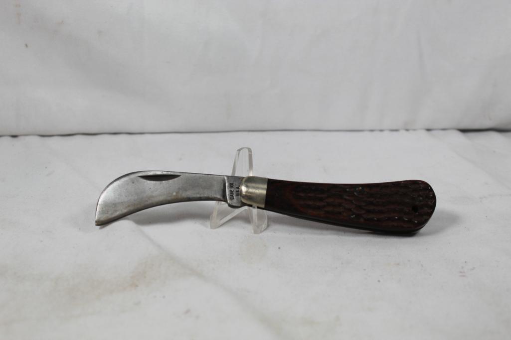 Case 1972 Hawk Bill. Jigged wood scales. Good condition for its age.