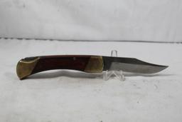 Schrade folding hunter model LB7. 3.75 inch blade. Wood scales. Original leather sheath. In good