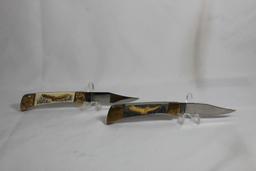 Two knives. Both single blade lockback folders with 3.25 inch blades. Brass and synthetic handles