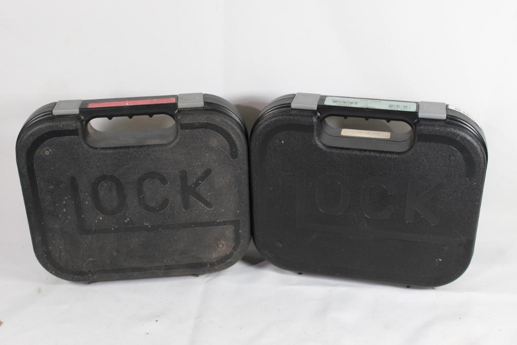 Two Glock pistol cases. Used, both are foam lined.