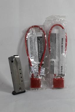 One Ruger double stack 9mm magazine. Used, and two cable gun locks. New.