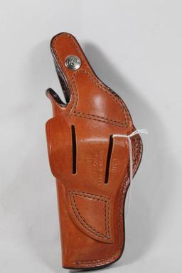 Bianchi lt brown leather belt snap holster for 4" revolver. Used in very good condition.
