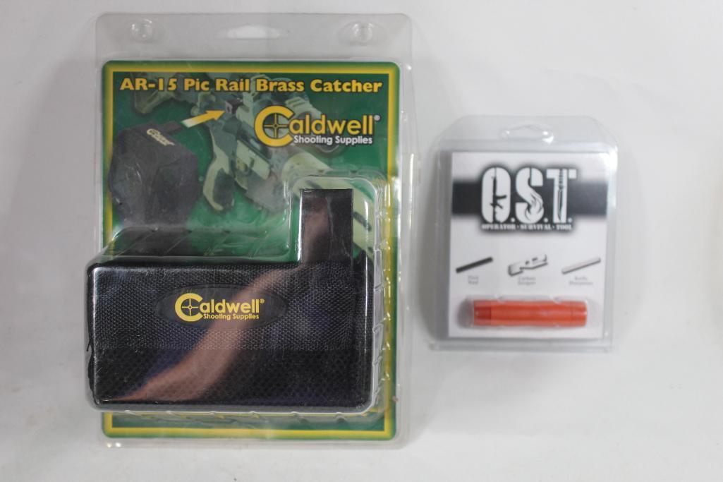 One Caldwell AR-15 Pic rail brass catcher and one OST survival flint fire starter. Both in packages.