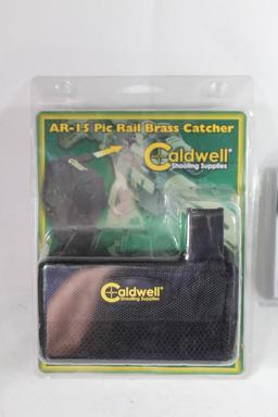 One Caldwell AR-15 Pic rail brass catcher and one OST survival flint fire starter. Both in packages.