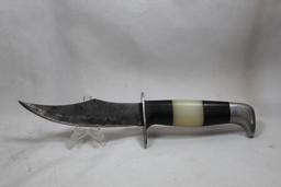Sheath knife with 4.5 inch blade and no markings. Synthetic black and white handle. Nice leather