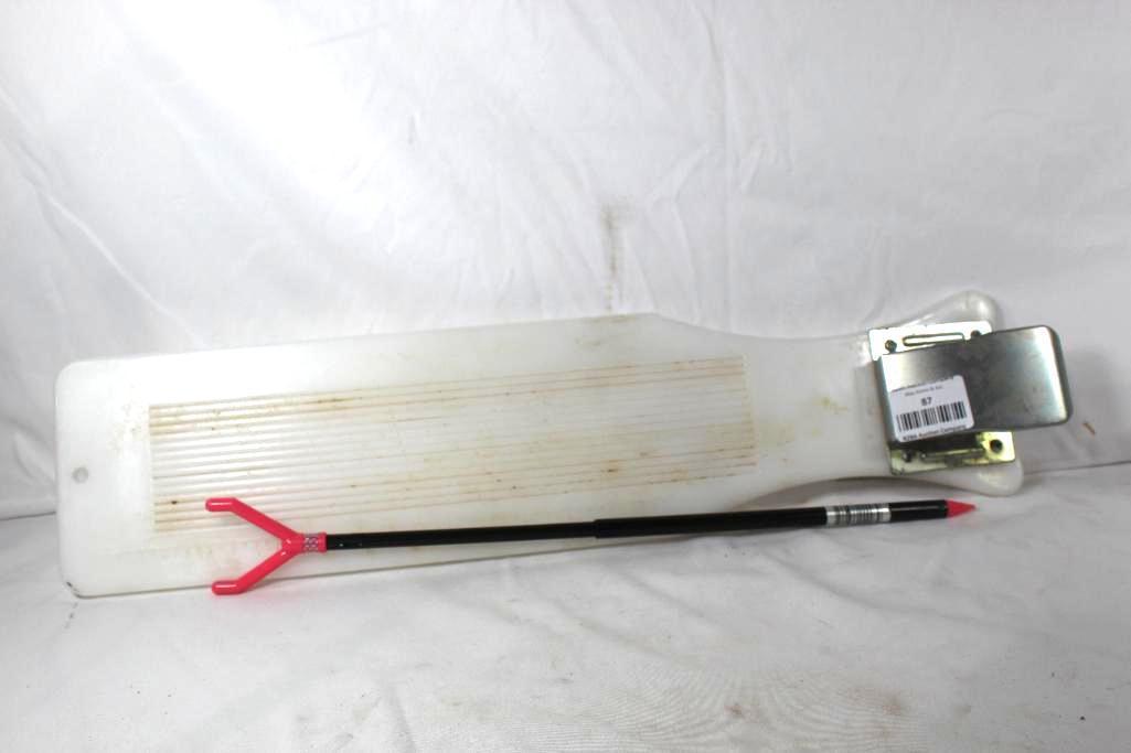 Plastic fish cleaning board with tail gripper and a fishing stick. Used.