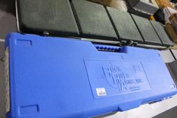 One fiberglass rifle case and one blue Rock River AR-15 factory rifle case.