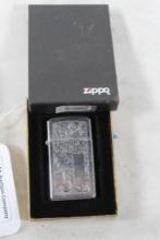 Small engraved Zippo lighter in box. Nice, but used.