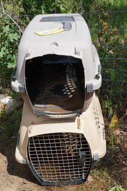 Two plastic pet carriers, one large and one med
