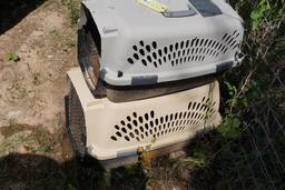 Two plastic pet carriers, one large and one med