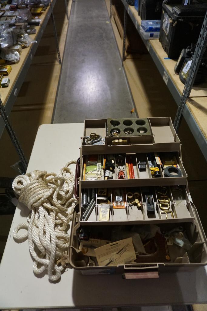 One Woodsman 3 tray tackle box with miscellaneous items, and one heavy nylon rope.