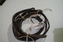 One set of bridle reins and two chin straps. Used.