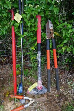 Lot containing tree trimmers, hedge clippers, splitting maul, boat paddle, and two golf clubs