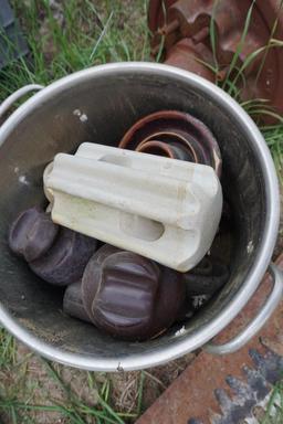 Bucket of old ceramic insulators.