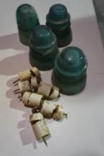 Four Hemingray-42 glass insulators and seventeen small porcelain insulators