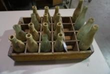 Wood crate with 18 old coke bottles