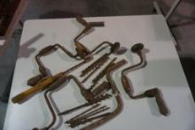 Miscellaneous old hand drills with bits, and one Model A hand starter crank.