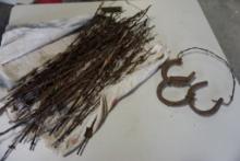 Bundle of barbwire samples. and a horse shoe hanger.
