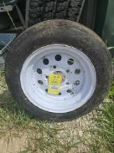 One trailer tire and rim. Used.