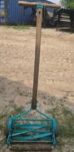 One manual push lawn mower. Used, works well.