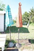 Two large patio umbrellas on pedestals