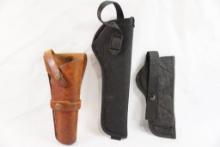 Three RH long barreled pistol holsters, one leather and two nylon