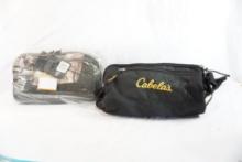 Two Cabela's range duffle bags, one camo new with tags and one black