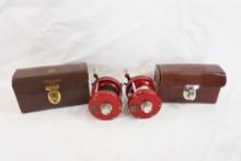 Two Abu Garcia Ambassadeur 5000 baitcasting reels in leather cases