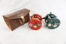 Two Abu Garcia Ambassadeur 5000 baitcasting reels one with broken leather case