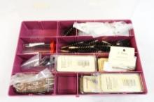 Plastic box of gun cleaning brushes and patch loops, new in pkgs