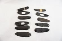 Eleven assorted plastic butt plates