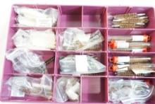Plastic container of gun cleaning mops and brushes