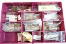 Plastic container of gun cleaning brushes