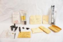 Bag of miscellaneous gun parts including complete slide for .22LR, firing pins and trigger bar