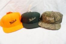 Three new Woolrich caps, one camo, one blaze orange and one hunter green