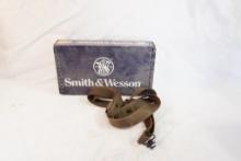 Smith & Wesson 38 S&W box and a nylon rifle sling