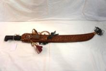 One Collins machete with a 24" blade and a tooled decorative scabbard.