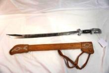 Mexican sword with tooled leather scabbard.
