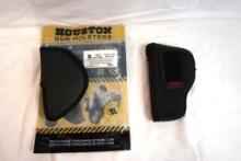 Two nylon pistol holsters. One belt loop, and one clip-on.