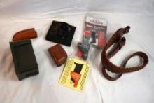 One super loader, two small leather sheaths, one woven leather rifle sling, one CCO plastic belt